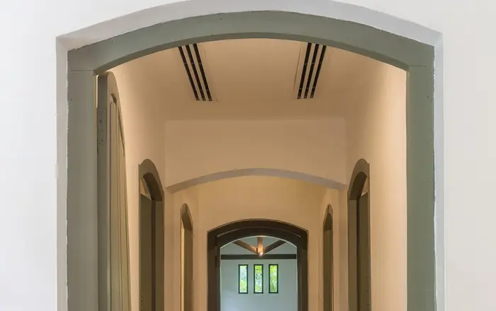 Corridor leading to indoor pool of spa at Amantaka luxury Resort & Hotel in Luang Prabang Laos front view