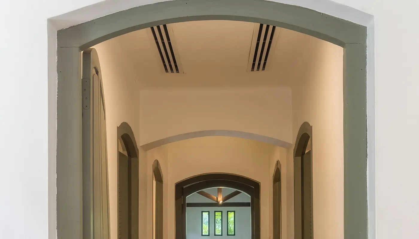 Corridor leading to indoor pool of spa at Amantaka luxury Resort & Hotel in Luang Prabang Laos front view
